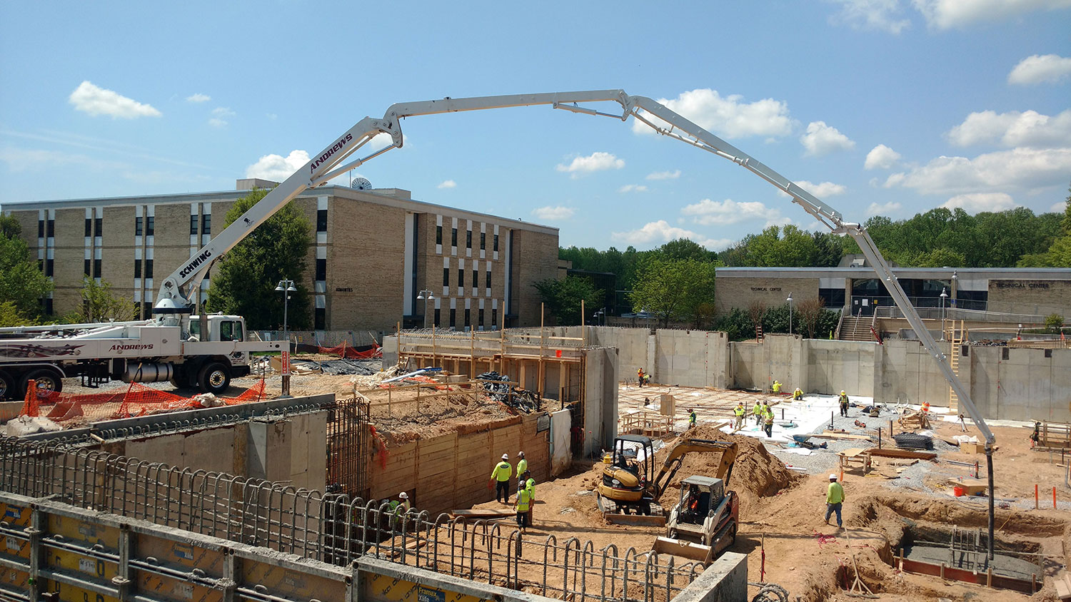 Andrews Equipment concrete boom pump on a job site