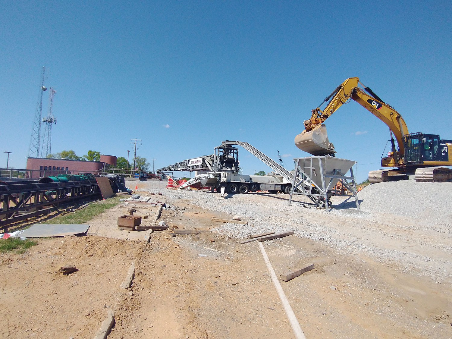 Andrews truck mounted conveyor being fed gravel by a excavator