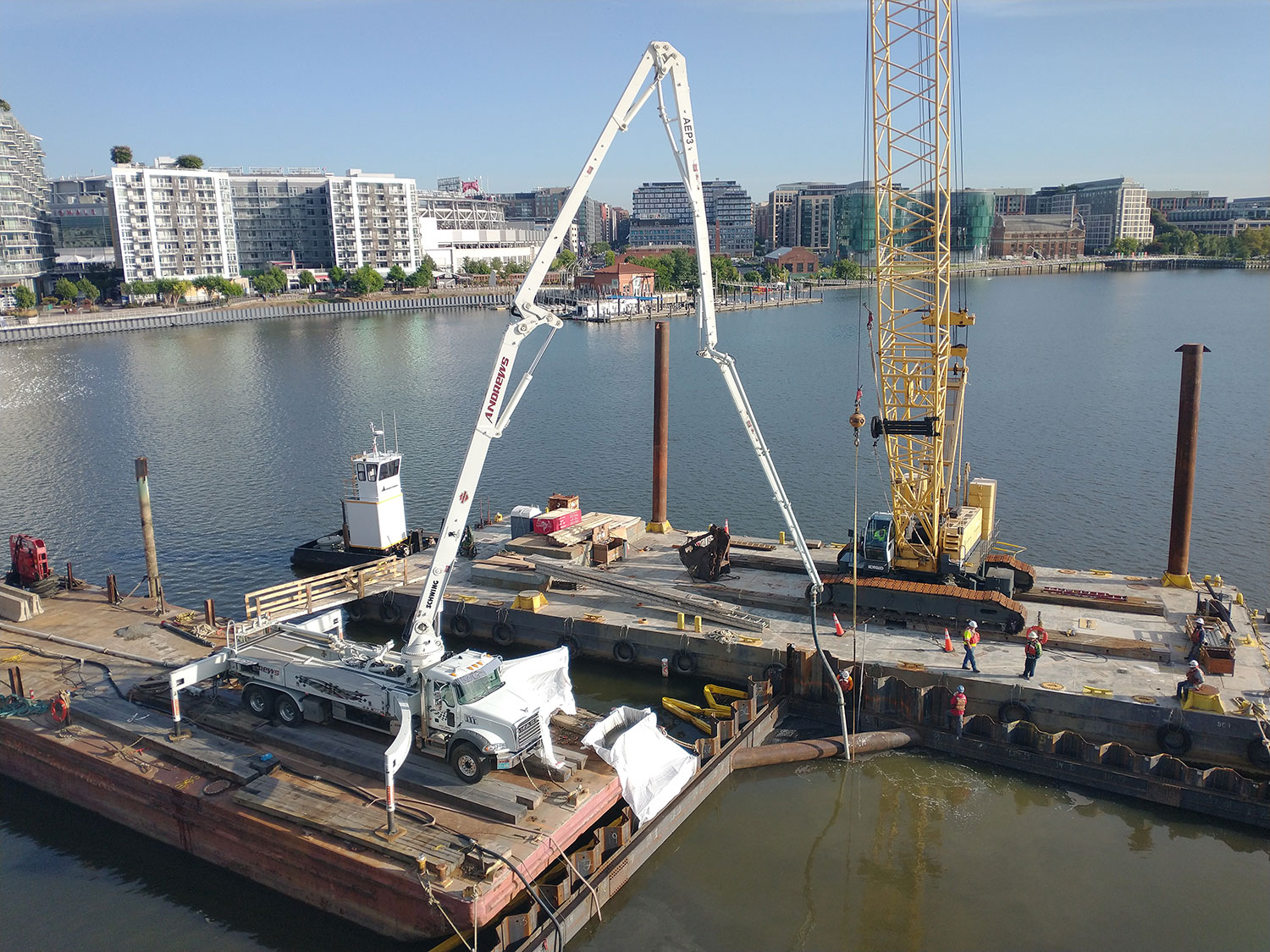 boom pump on a barge pumping concrete under water