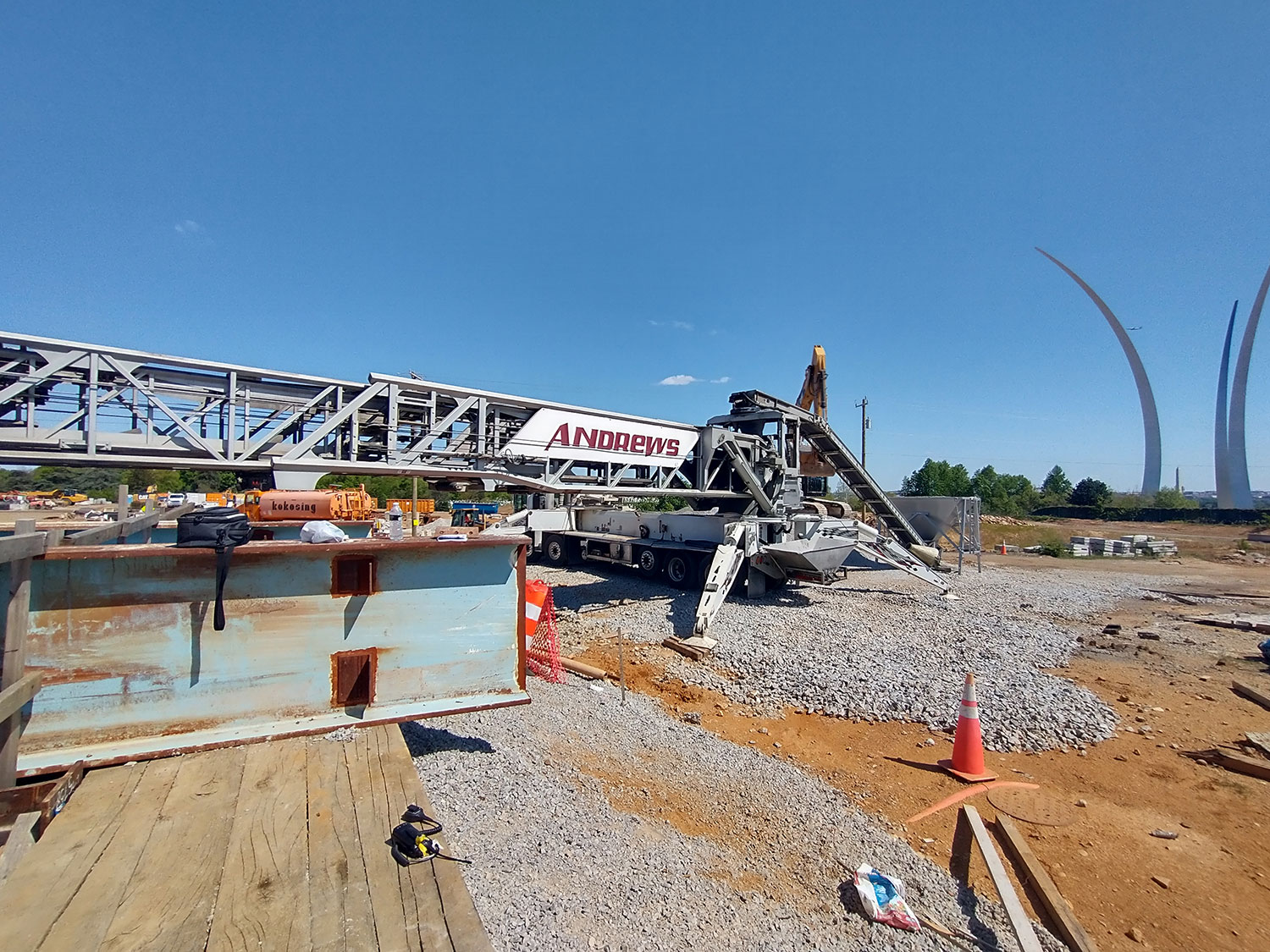 Andrews truck mounted conveyor being fed gravel by a excavator