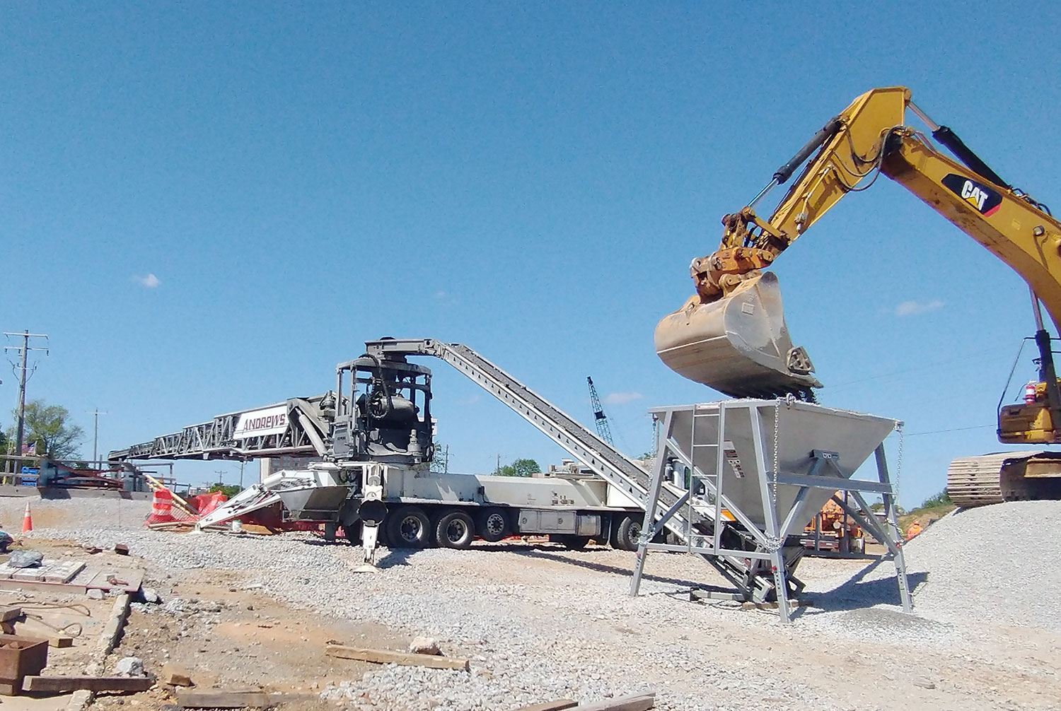 Andrews truck mounted conveyor being fed gravel by a excavator