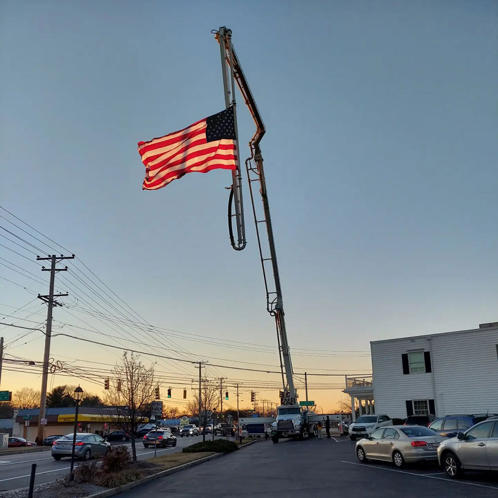 Concrete boom pump with American Flag raised