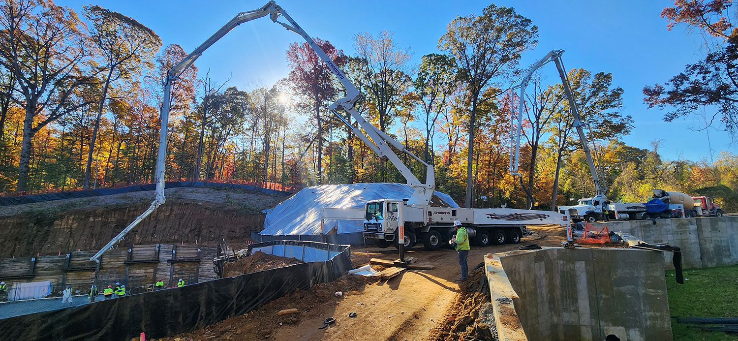 boom pumps pouring concrete on a job site